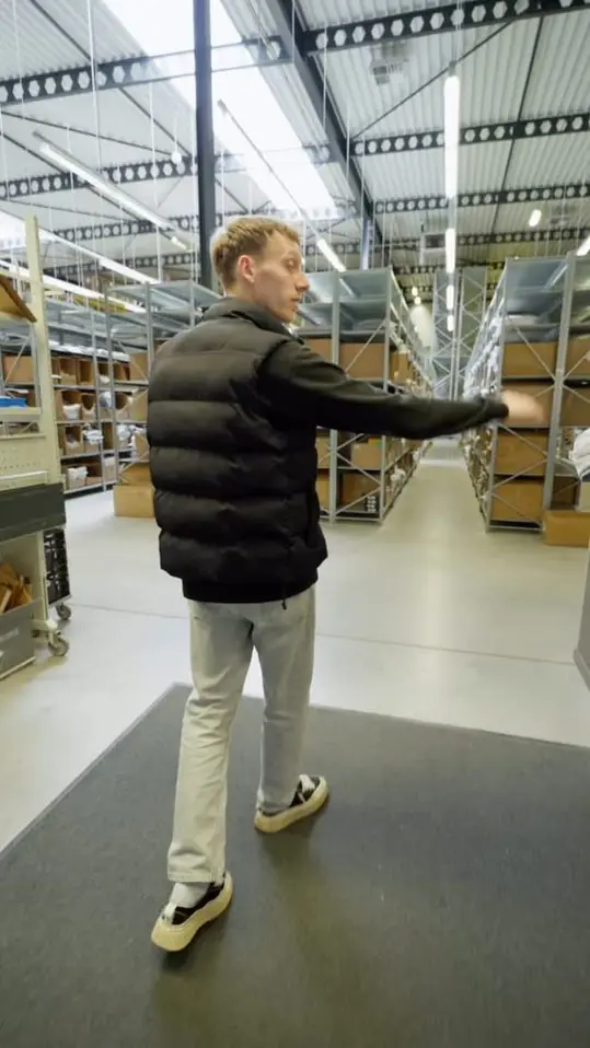 Reelcover van Innostock: een medewerker loopt door een magazijn met stellingen.